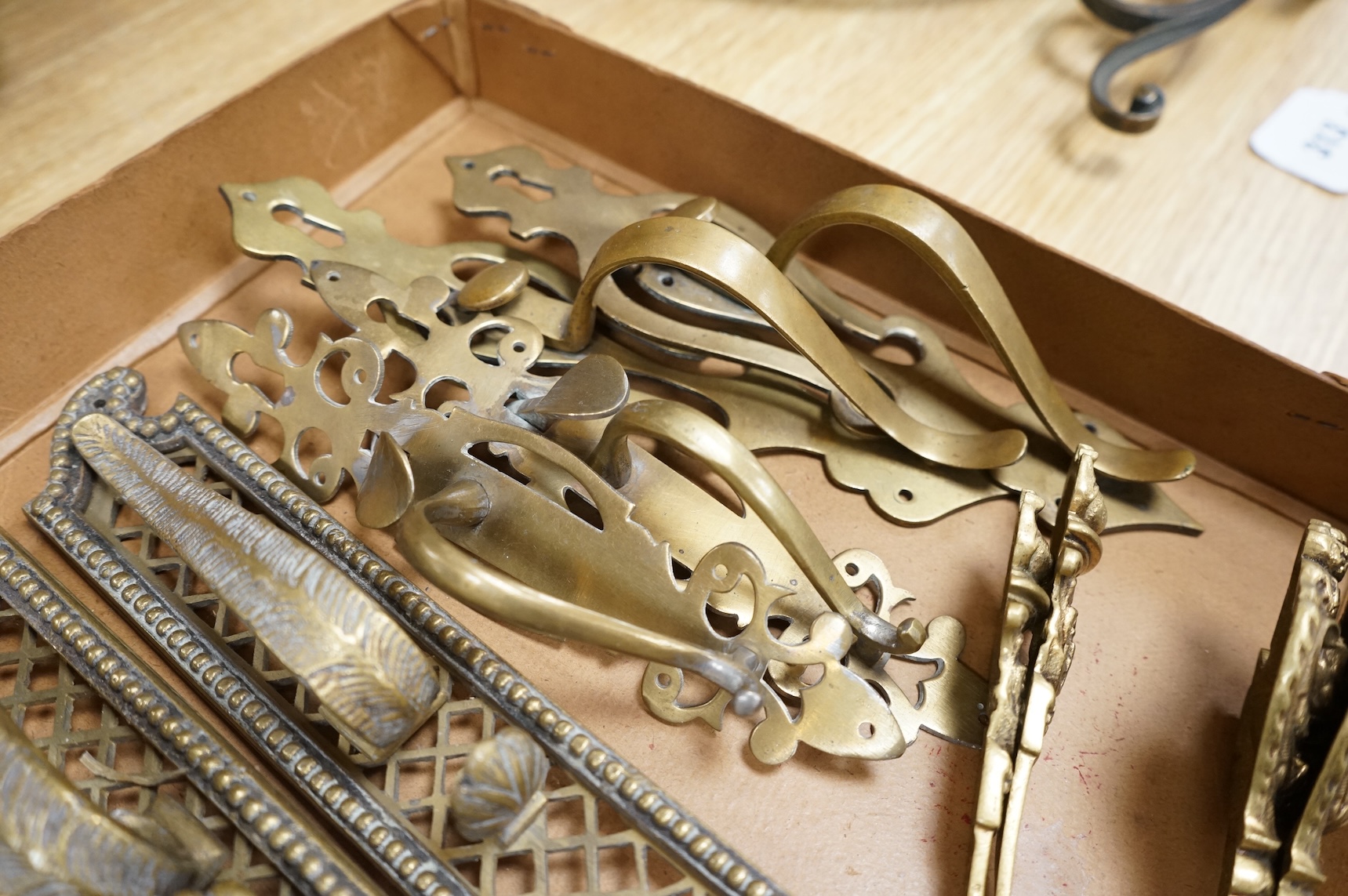A collection of 19th century cast brass tie backs, largest 26cm high
